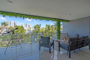 a view from the balcony of a condo with a telescope at Waterfront Luxe Condo - Close to beach in Hallandale Beach