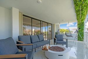 a living room with a couch and chairs and a table at Waterfront Luxe Condo - Close to beach in Hallandale Beach