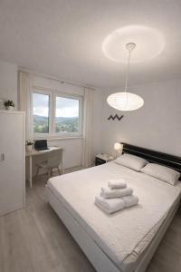 a bedroom with a bed with towels on it at Urban Nest Nova Gorica in Nova Gorica