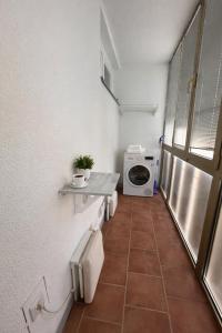 a bathroom with a toilet and a washing machine at Urban Nest Nova Gorica in Nova Gorica