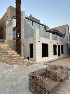 a building with a couch in front of a palm tree at Wadi Hanifa View وادي حنيفة ڤيو in Riyadh