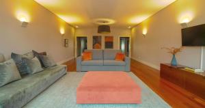 a living room with a couch and a tv at ALIADOS by YoursPorto in Porto +12 photos