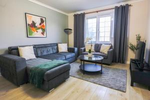 a living room with a couch and a table at Burnvale Apartment in Livingston