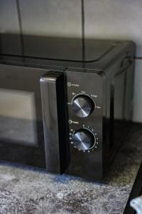 a black toaster oven sitting on top of a counter at Burnvale Apartment in Livingston +31 photos