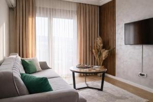 a living room with a couch and a table at Apartman Jaman - Novi Pazar in Novi Pazar
