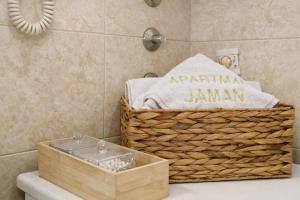 a basket sitting on top of a toilet in a bathroom at Apartman Jaman - Novi Pazar in Novi Pazar +34 photos