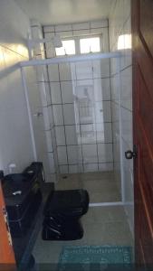 a bathroom with a toilet and a glass shower at Pousada Pérola dos Corais Maceió in Maceió +26 photos