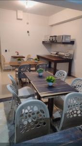 a dining room with wooden tables and chairs at Pousada Pérola dos Corais Maceió in Maceió