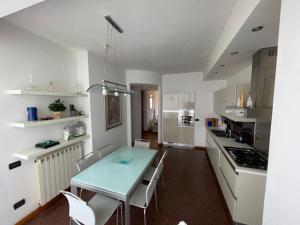 a kitchen with a table and chairs in a room at Charming beach front apartment in Viareggio