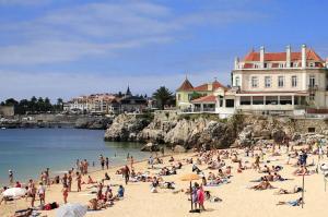 a group of people on a beach near the water at Double Room near Lisbon & Sintra in Queluz