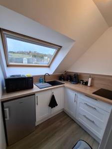 a small kitchen with a sink and a window at Studio l'écluse in Le Tréport +13 photos