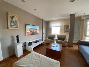 a living room with a couch and a table at Charming beach front apartment in Viareggio