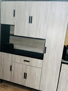 a large wooden cabinet with drawers in a room at Kasi Retreat in Northam +8 photos