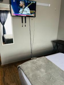 a tv on a wall in a room with a bed at Kasi Retreat in Northam