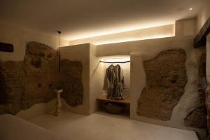 a bedroom with stone walls and a bed with a light at Espacio Biocompatible - Villa Raíz in Requena