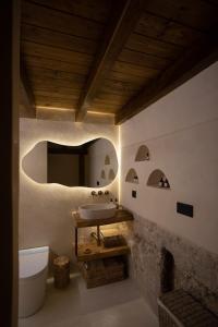 a bathroom with a sink and a stone wall at Espacio Biocompatible - Villa Raíz in Requena +49 photos