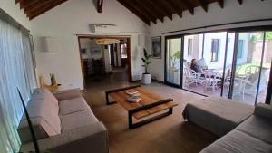 a living room with a couch and a table at Beach House AP in Miramar
