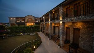 an empty courtyard of a building at night at Corbett Elegant Retreat Jim Corbett in Rāmnagar