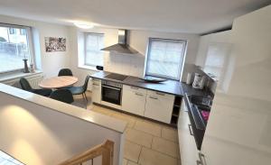 a kitchen with a sink and a stove top oven at Bodensee Ferienwohnung Claudia 4 in Friedrichshafen