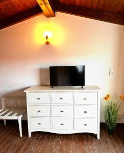 a white dresser with a television on top of it at Villa LUMIè Stintino in Stintino