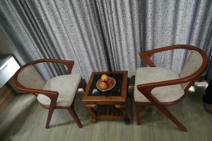 two chairs and a table with a bowl of fruit on it at Winter Whisper in Jāmb