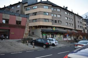 a car parked in front of a large building at Vista Baqueira in Vielha
