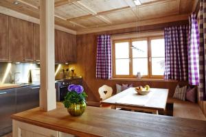 a kitchen with a table and a dining room at Suite Buche - Chalet Bergerhöh in Bad Wiessee +50 photos