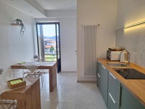 a kitchen with a sink and a counter top at Affittacamere La Polse in Osoppo