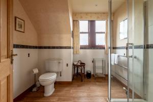 a bathroom with a toilet and a glass shower at Melon Park - Elie in Elie +45 photos