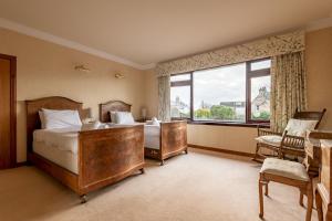 a bedroom with two beds and a large window at Melon Park - Elie in Elie