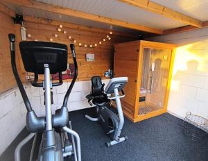 a room with a gym with a treadmill and a television at Wellness Apartments Ra in Primošten