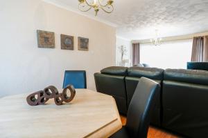 a living room with a table and a couch at Jake's House in Airdrie +27 photos