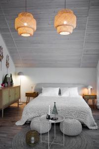 a bedroom with a bed with two lights and a table at Апартаменти Rest Hill in Vorokhta