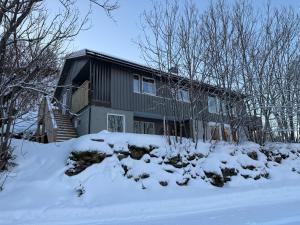 a house covered in snow in front at Langhaugen - Kabelvåg in Kabelvåg