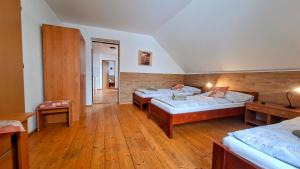 a large room with two beds and a hallway at Penzion a restaurace Polnička in Polnička +74 photos