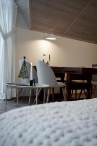 a room with a table and chairs and a piano at Апартаменти Rest Hill in Vorokhta