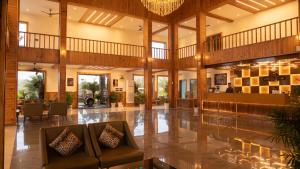 a large lobby with a chandelier and a couch at Corbett Elegant Retreat Jim Corbett in Rāmnagar +172 photos