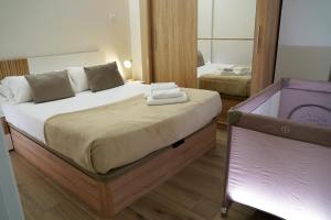a bedroom with a large bed and a mirror at Casa Dolce Casa - Elegant 3BR Apartment Near Metro & Beach,Valencia in Valencia +24 photos