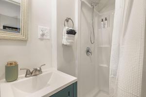 a white bathroom with a sink and a shower at Mountain View Cottage by Carolina Mornings in Waynesville +38 photos