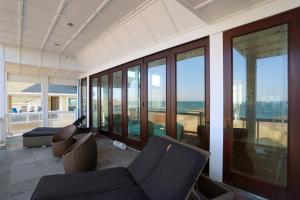a living room with a view of the ocean at Good Karma Retreat - Nags Head MP 15.5, Oceanfront, Elevator, Pool, Hot Tub, Pets OK, Flex Stays in Nags Head +80 photos