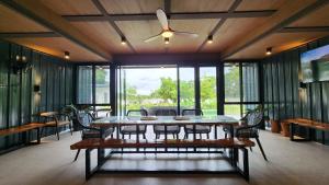a dining room with a table and a ceiling fan at Solunara Malolos in Malolos