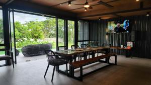 a dining room with a table with chairs and a tv at Solunara Malolos in Malolos