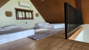 two beds are in a room with a staircase at Solunara Malolos in Malolos +29 photos