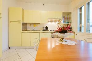 a kitchen with a table with a vase of flowers on it at Relax Stay vicino Padova e Brenta in Vigonza
