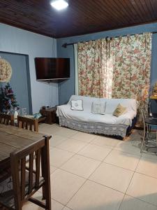 a living room with a bed and a christmas tree at Sentirse en casa in Puerto Iguazú
