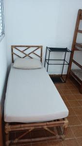 a bed in a room with a white mattress at Bruno Pereira in Guarujá