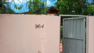 a door on a pink wall with the number eighty fourteen at Bruno Pereira in Guarujá