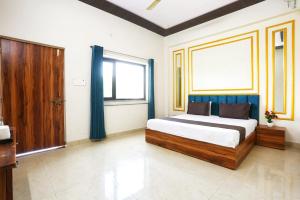 a bedroom with a bed and a large window at The Prem Royal Resort & Hotel in Dāūd Khān