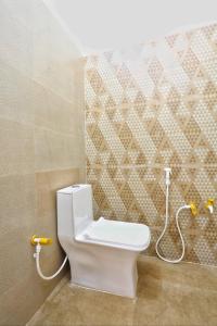 a bathroom with a toilet with a hose at The Prem Royal Resort & Hotel in Dāūd Khān