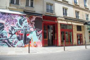a building with graffiti on the side of a street at Hotel La Louisiane in Paris +119 photos